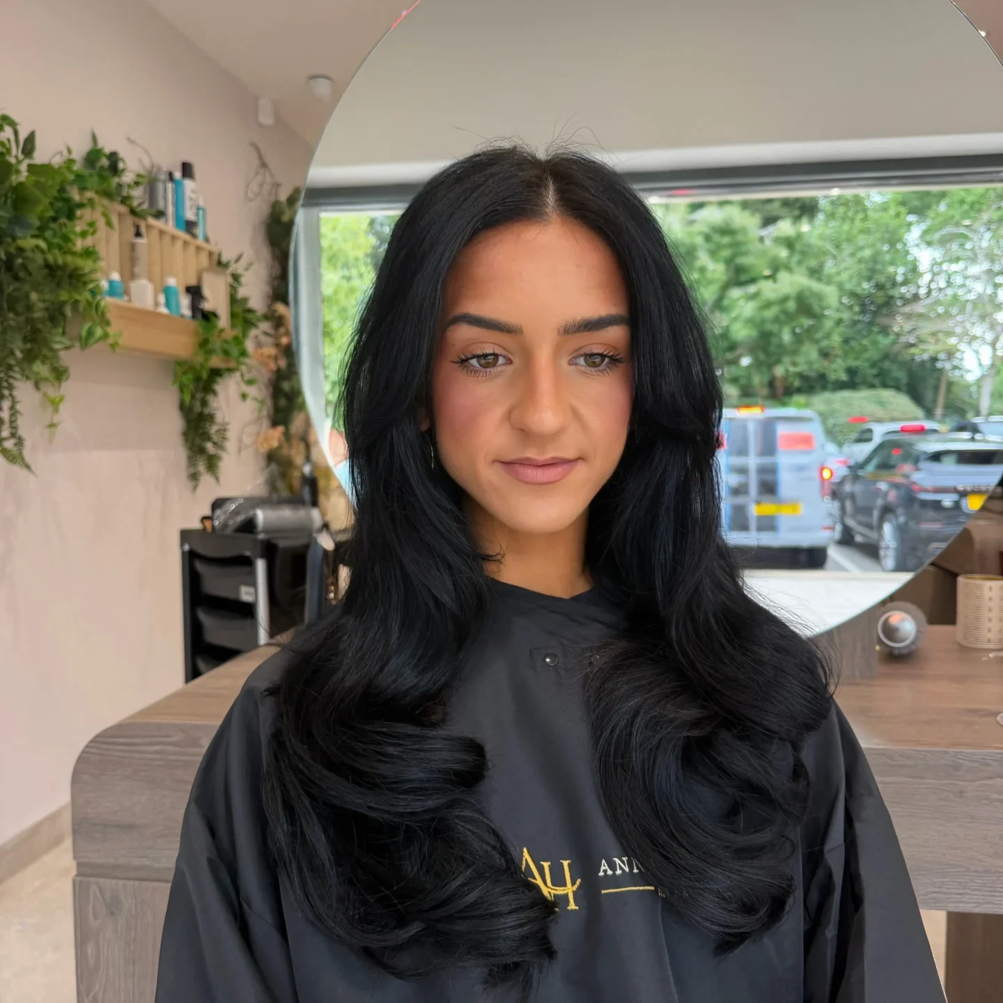 Woman sitting in a salon chair with long hair